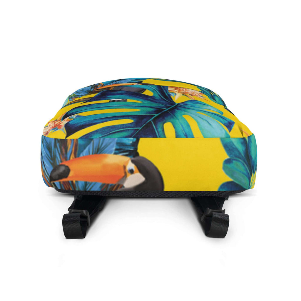 MOCHILA TUKAN URBAN UNISEX con diseño tropical en tonos amarillos y verdes, ideal para un estilo urbano y moderno.