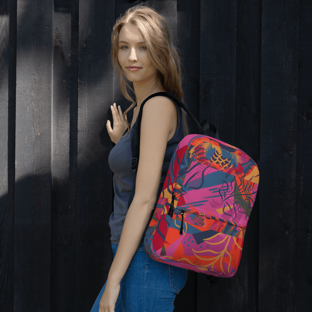 🔵 FLORES 🔵 - Mochila URBAN Unisex 🔵 sobre el hombro de una mujer, con diseño urbano colorido y estampado floral.