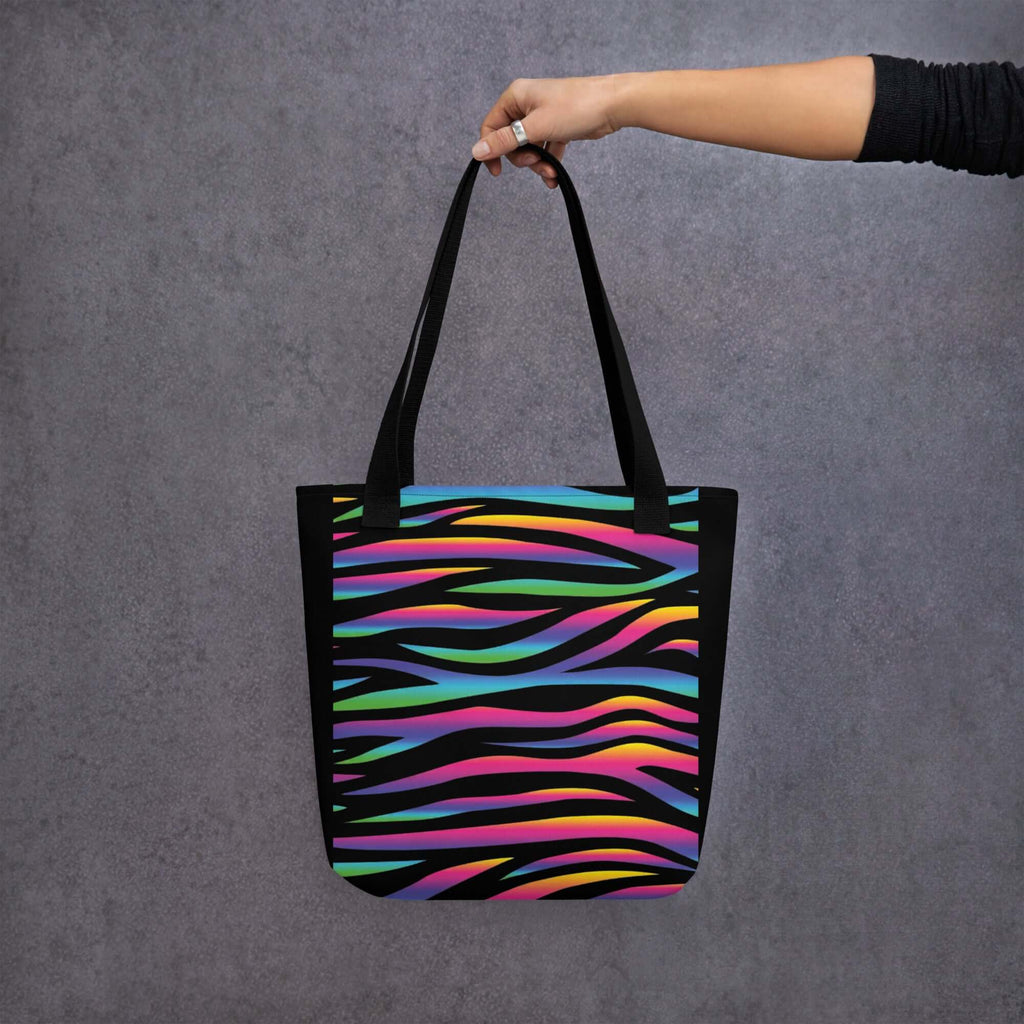 BOLSA CEBRA COLORES en mano, bolsa de tela urbana con diseño vibrante y llamativo en colores brillantes.